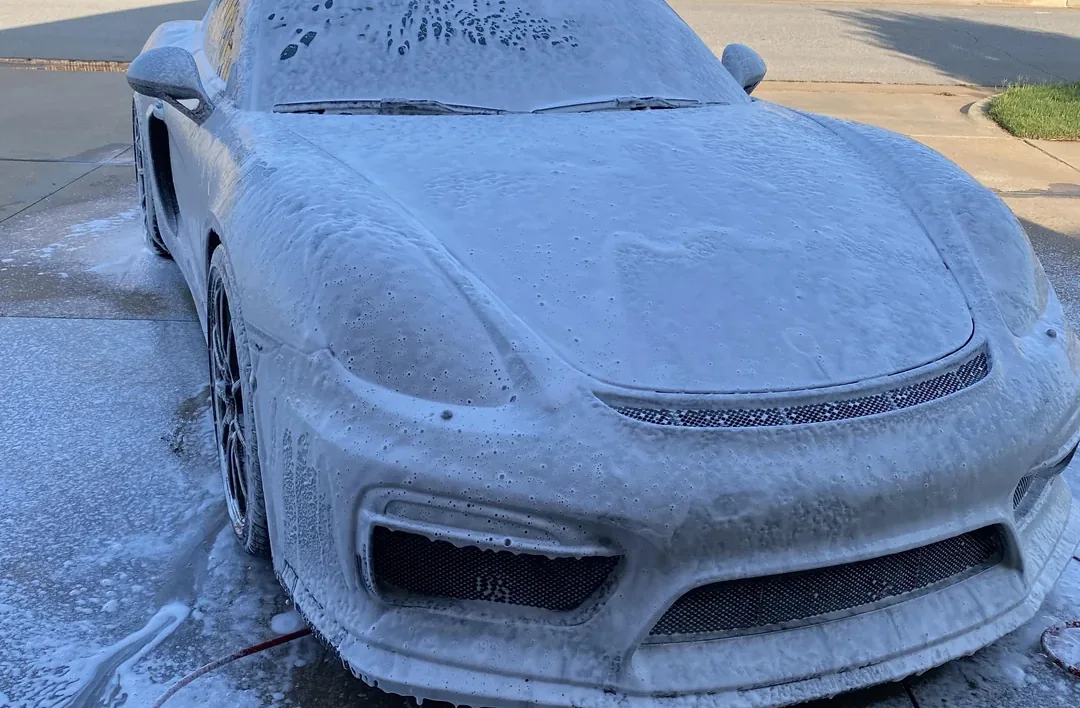 Exterior wash and decontamination on a dark vehicle